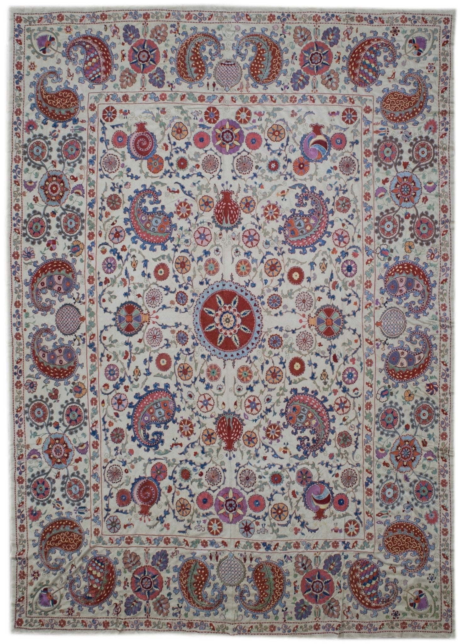 Handmade Uzbek suzani featuring intricate silk floral and paisley embroidery on a silk base.