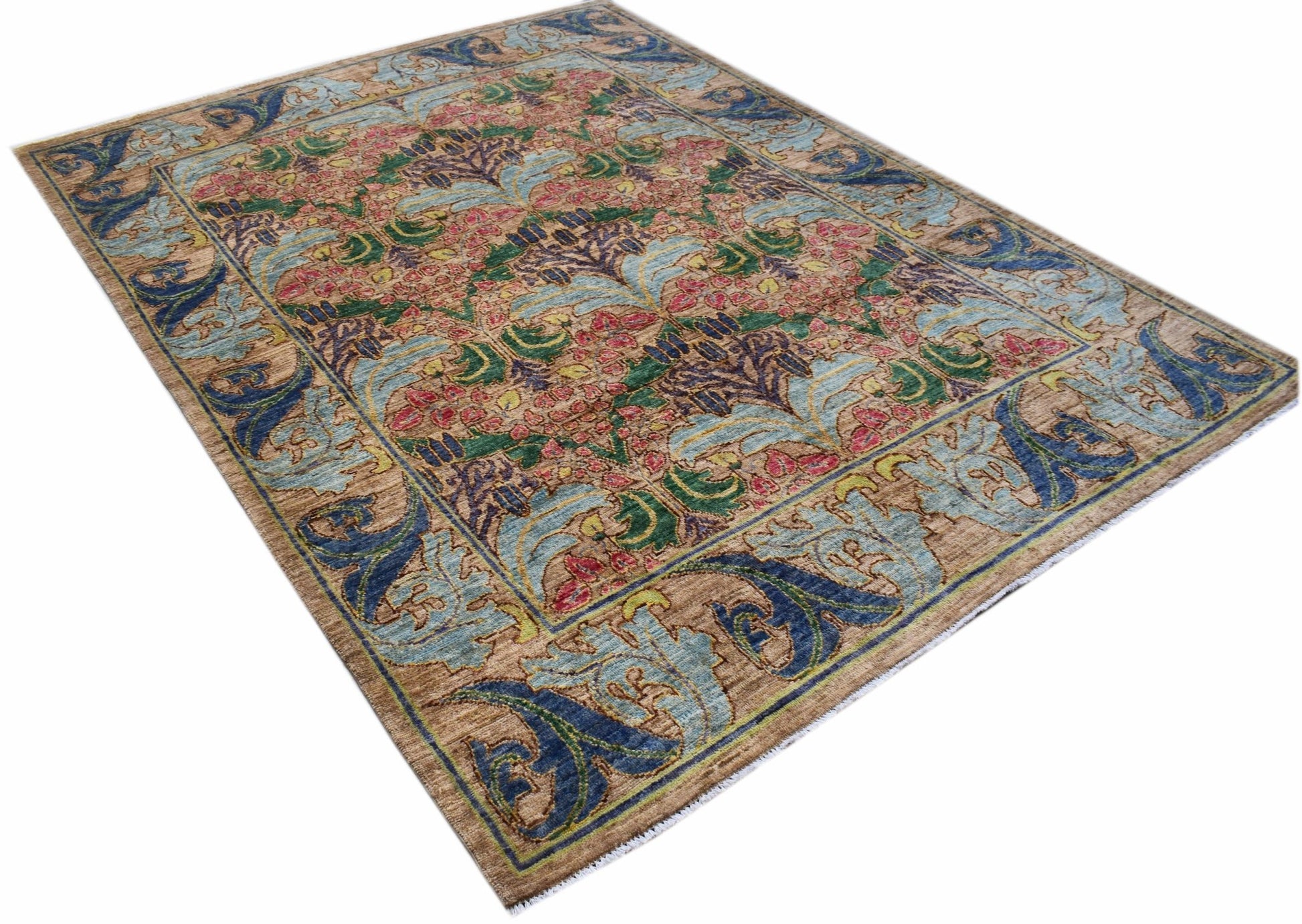 A handwoven Afghan rug featuring a botanical floral pattern in blue, green, and pink on a tan base.