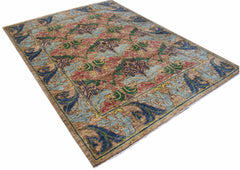 A handwoven Afghan rug featuring a botanical floral pattern in blue, green, and pink on a tan base.