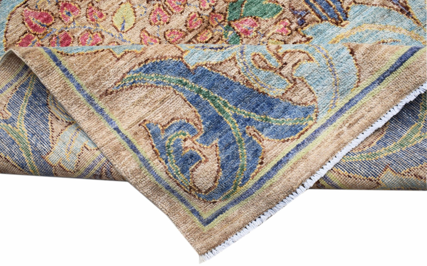 A handwoven Afghan wool rug featuring a floral botanical pattern in blue, pink, and tan tones.
