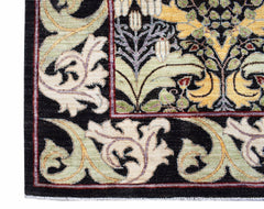 A corner view of a handwoven Afghan rug featuring a black background with ornate floral patterns.