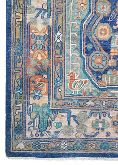 A handmade Afghan rug featuring a traditional geometric pattern in blue, orange, and beige tones.