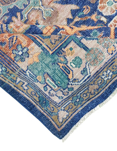 A handwoven Afghan rug featuring a traditional geometric pattern in blue, orange, and beige tones.