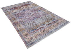 A transitional Oushak rug featuring a distressed pattern in muted tones of pink, blue, and tan.