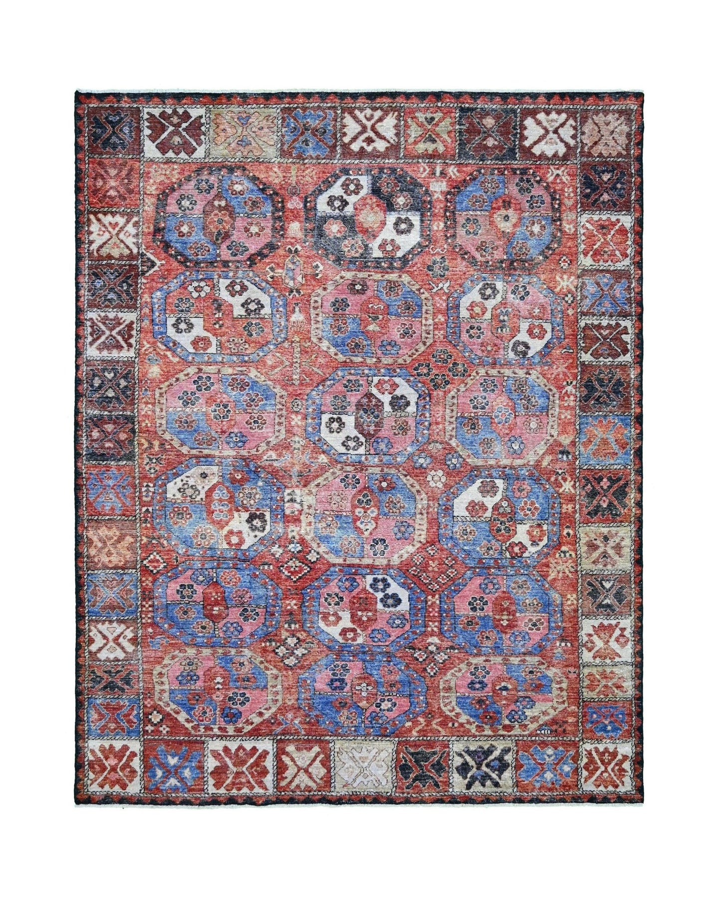 A transitional Afghan rug featuring a traditional red and blue geometric elephant foot pattern.