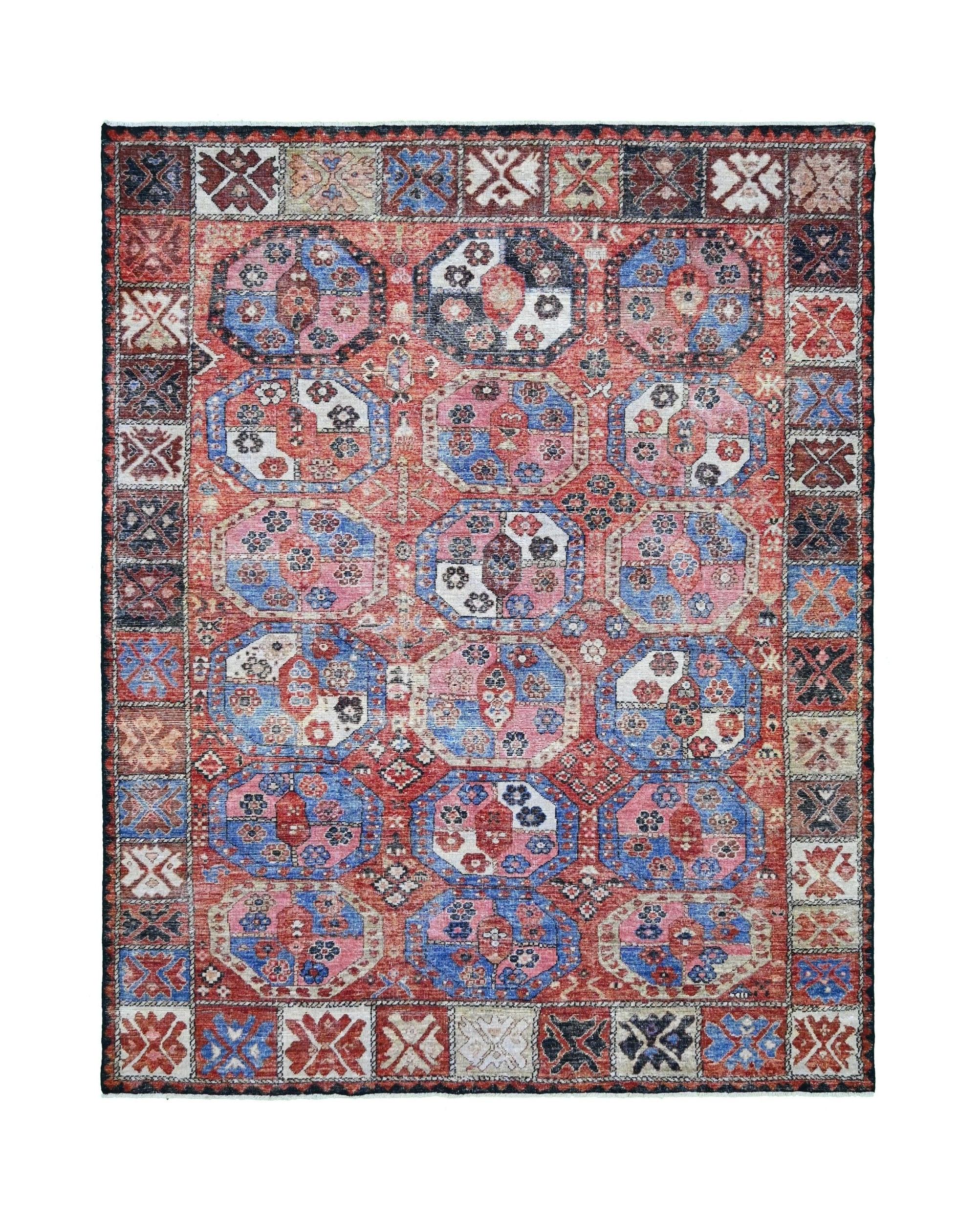 A transitional Afghan rug featuring a traditional red and blue geometric elephant foot pattern.