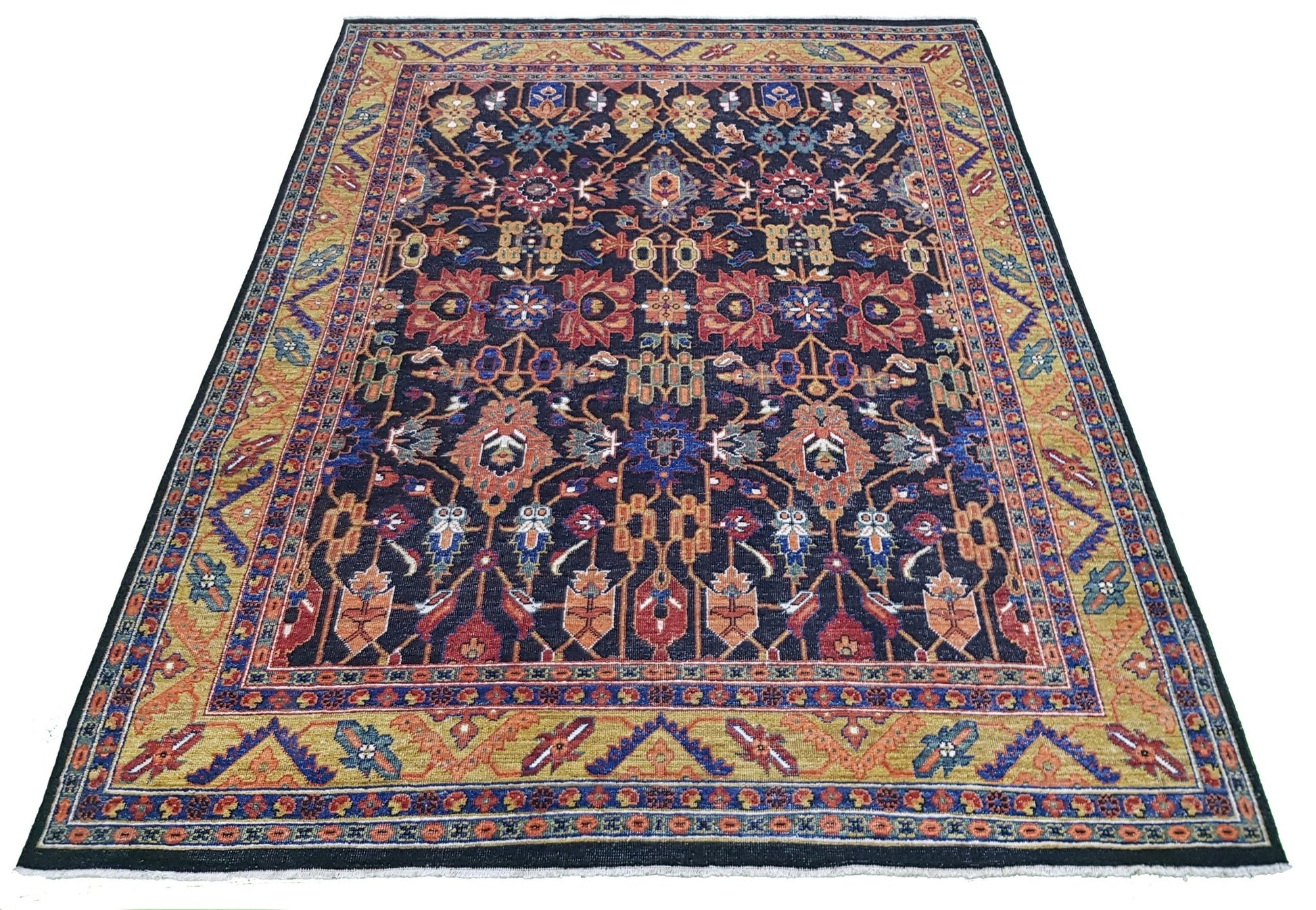 A hand-knotted Afghan rug featuring a dark blue field with intricate floral and medallion patterns.