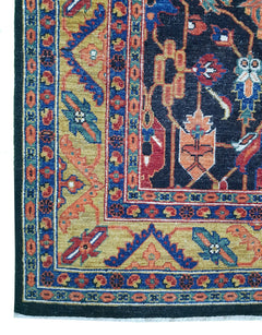A transitional Afghan rug featuring a dark blue field with intricate floral and medallion patterns.