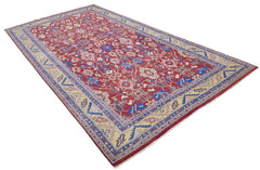 A rectangular Afghan rug featuring a red field with intricate floral patterns and a beige border.