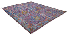 A handmade Afghan rug featuring a traditional Tree of Life pattern in vibrant purple and blue tones.