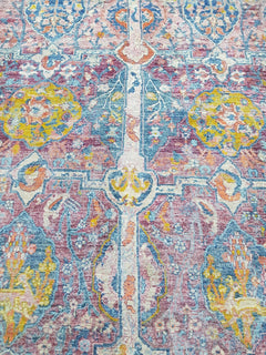 A handwoven Afghan rug featuring a colorful, intricate Tree of Life pattern in a low-pile design.