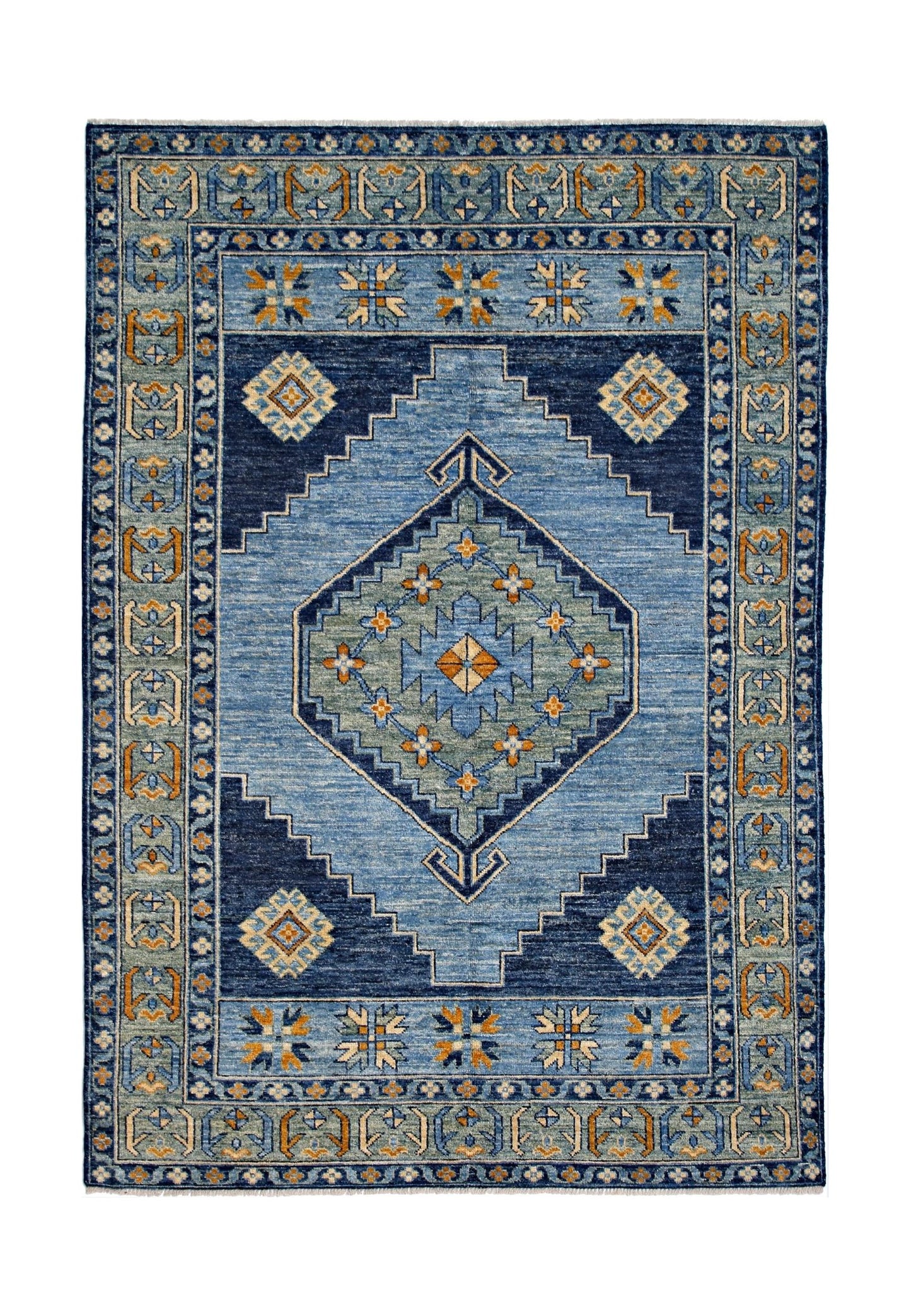 A handmade wool rug featuring a blue geometric diamond pattern with orange and cream accents.