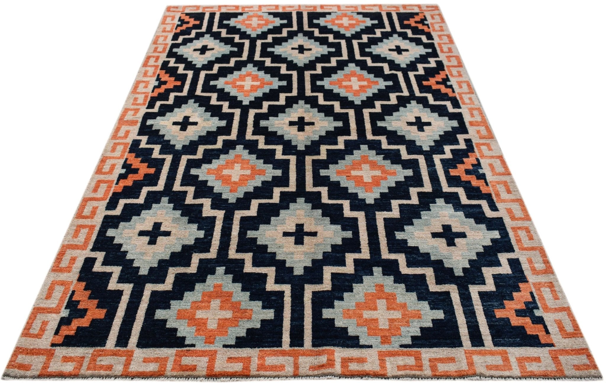 A hand-knotted wool rug featuring a geometric pattern in navy, light blue, and orange.