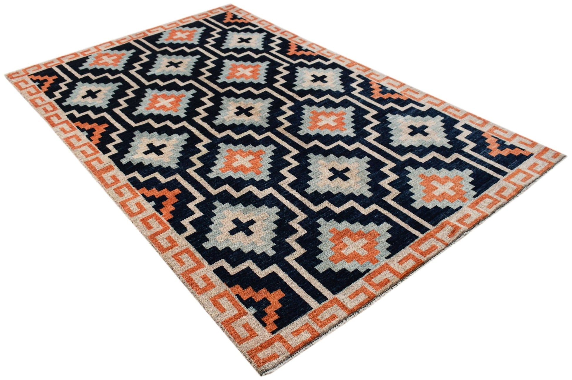 A hand-knotted wool rug featuring a dark blue background with geometric orange and grey patterns.