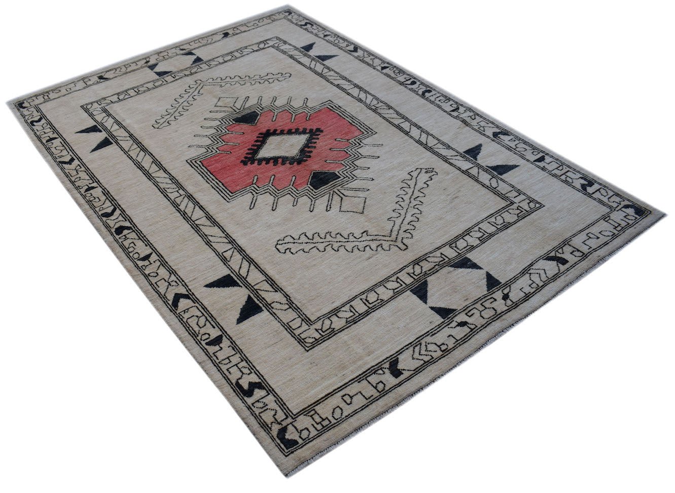 A handmade wool rug from Afghanistan featuring a central geometric medallion on a beige field.