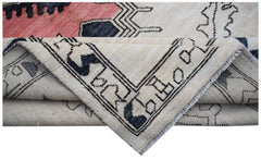 A corner of a handmade wool Transitional Kohi rug featuring a geometric pattern in cream and black.