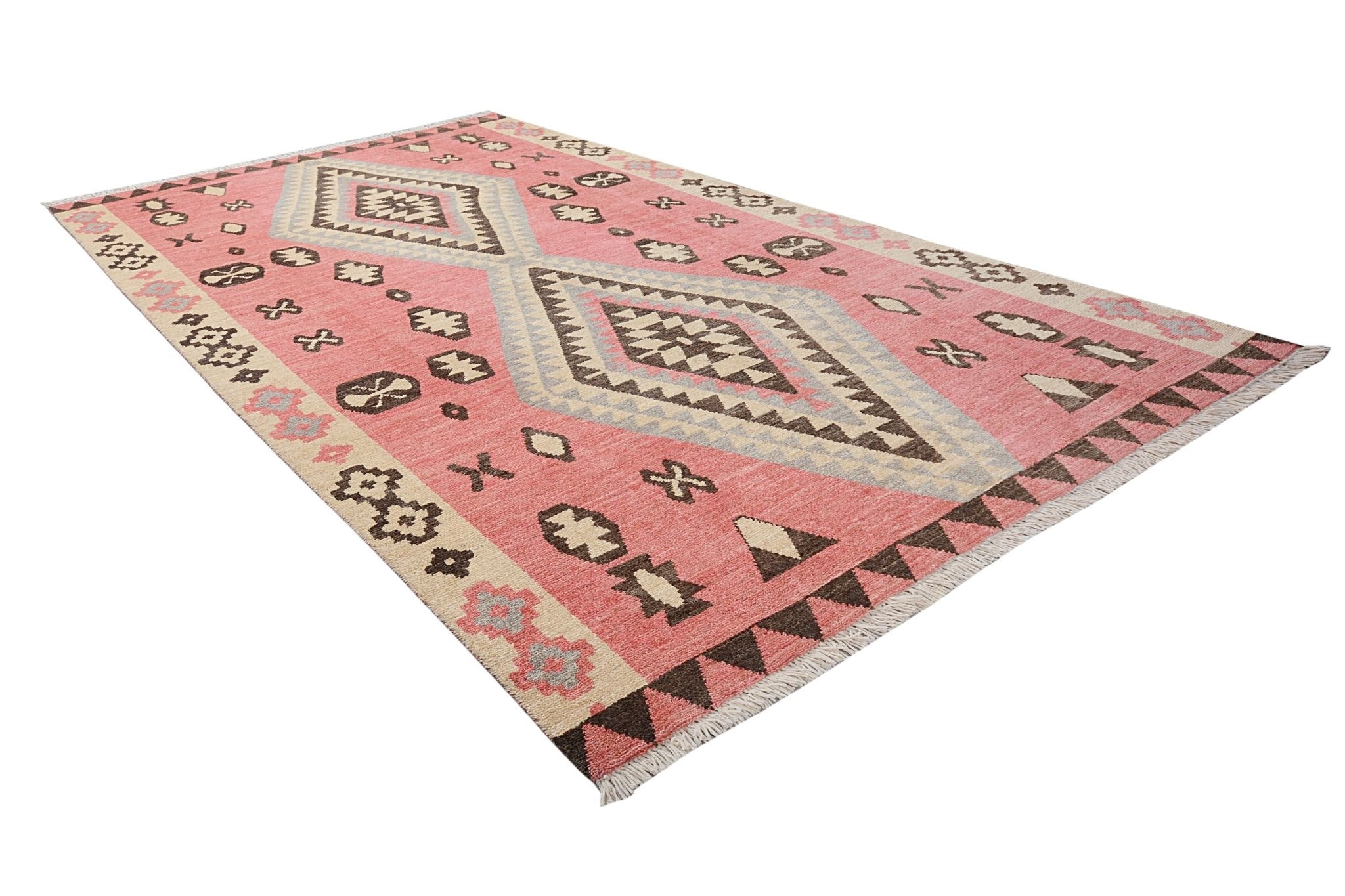 A handmade transitional Kohi rug featuring a pink field with geometric diamond and tribal motifs.