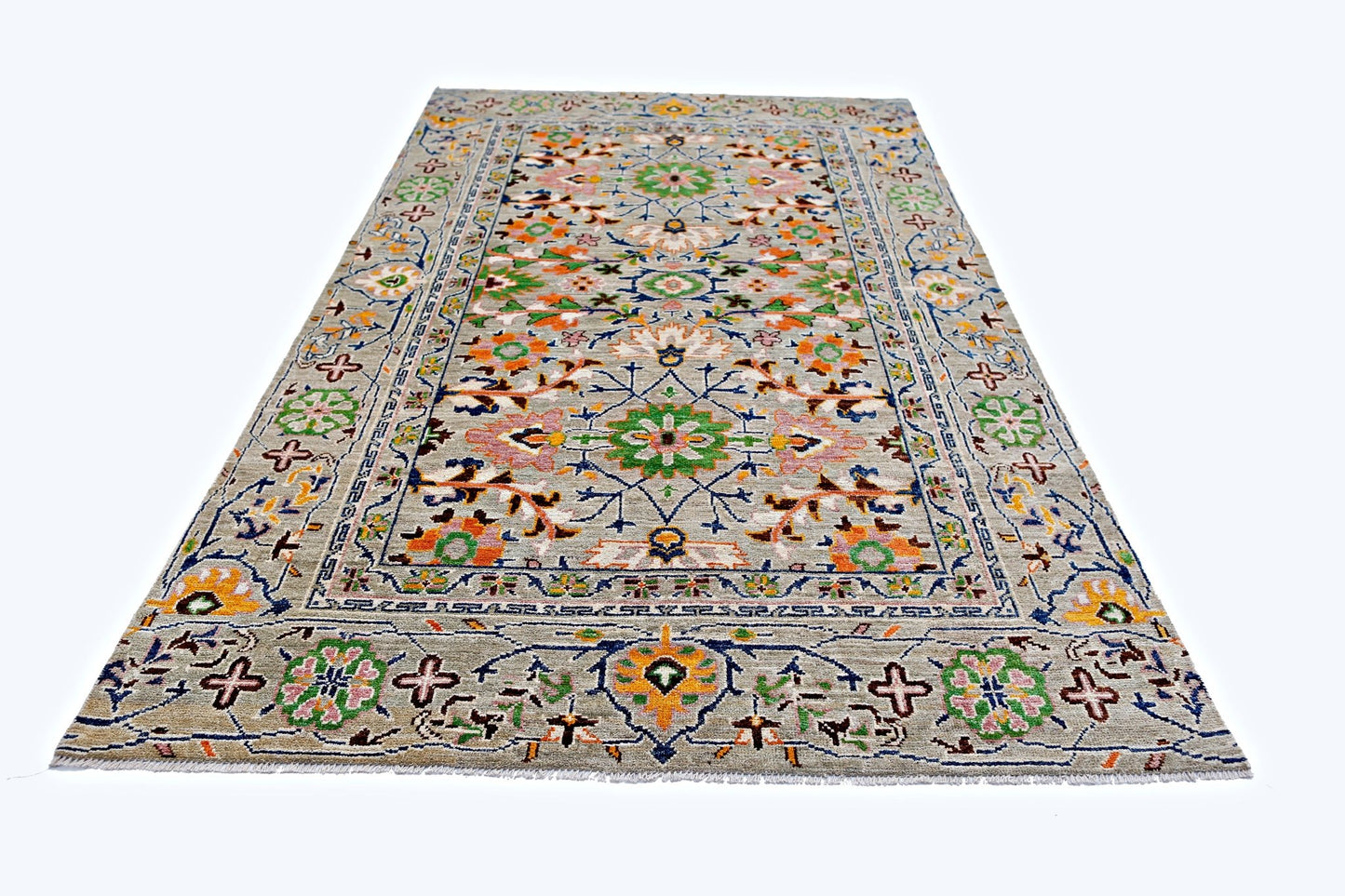 A handmade transitional Kohi rug from Afghanistan featuring a colorful floral pattern on a grey field.