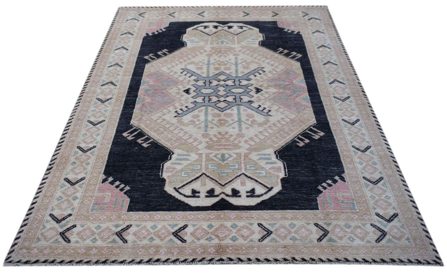 A handmade wool rug from Afghanistan featuring a central geometric medallion on a dark field.