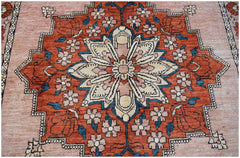 Handmade Afghan Kohi wool rug featuring a central floral medallion in rust, cream, and blue tones.