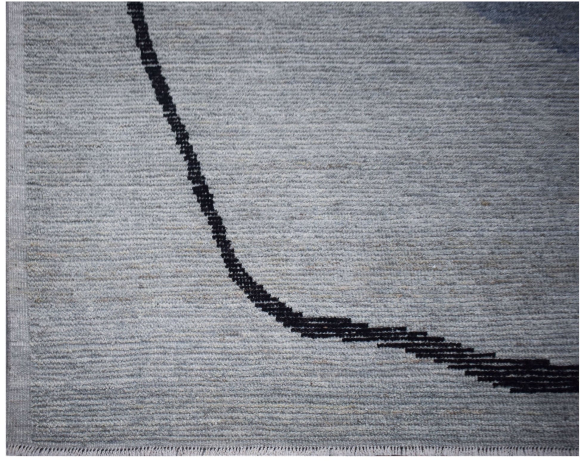 A hand-knotted Afghan rug in grey wool featuring a minimalist black curved line design.