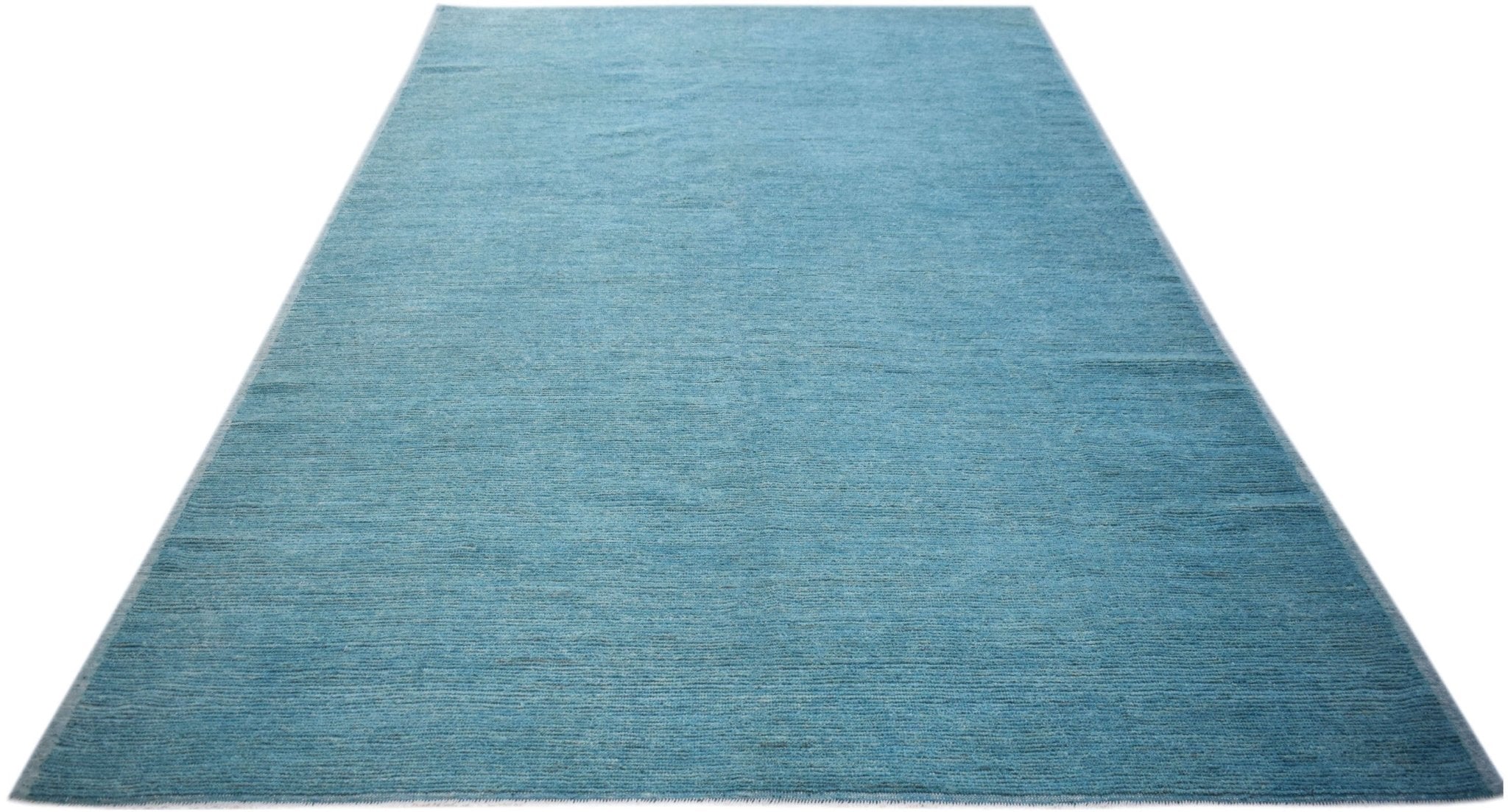 A rectangular, hand-knotted Afghan Kohi rug in a solid, textured blue wool.