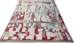 A hand-knotted Afghan rug featuring a geometric abstract pattern in red, blue, and grey tones.