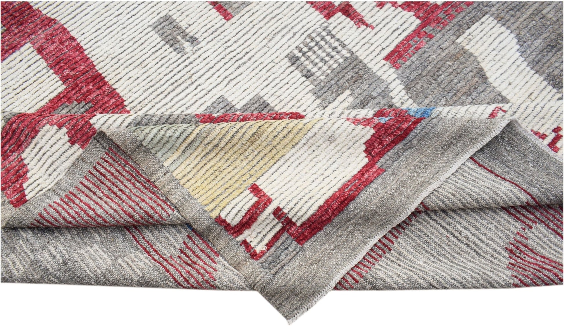 A hand-knotted Afghan wool rug featuring a geometric pattern in red, grey, and cream tones.