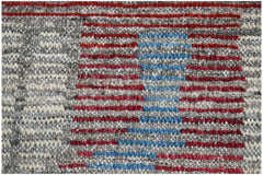 A hand-knotted wool rug featuring a textured pattern of horizontal red and blue stripes on grey.