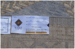 A hand-knotted wool rug featuring a traditional pattern in a soft blue and beige color palette.
