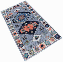 A handwoven transitional Oushak rug featuring a geometric pattern in blue, orange, and cream.