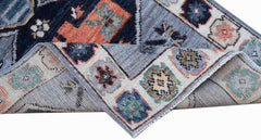 A handwoven transitional Oushak rug featuring a geometric floral pattern in blue and orange tones.