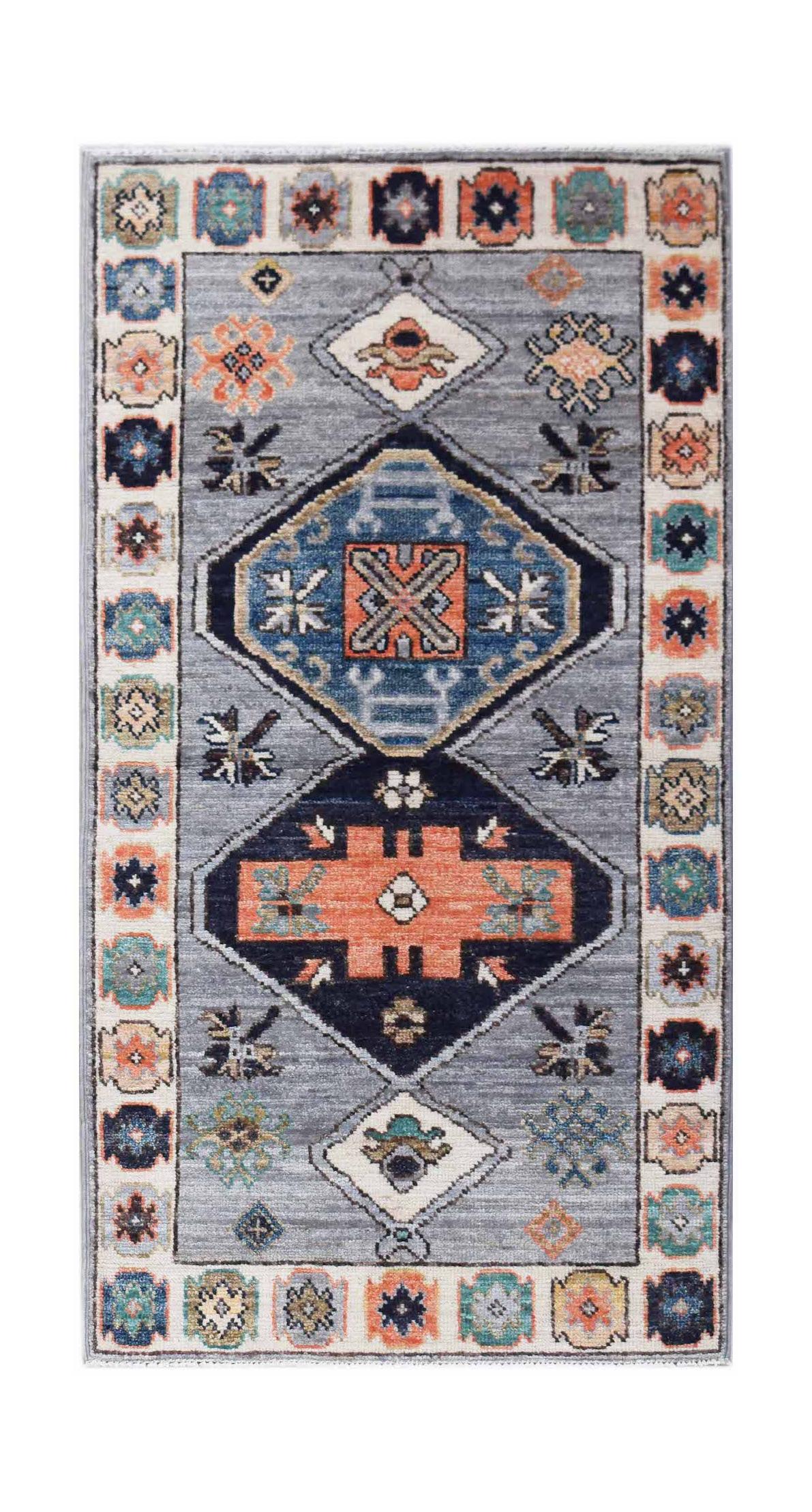 A handwoven transitional Oushak rug featuring geometric medallions in blue and orange on a grey field.
