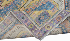 A handwoven transitional Oushak rug featuring a colorful floral pattern in wool.