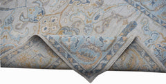 A handwoven transitional Oushak rug featuring a blue and beige floral pattern on a light background.
