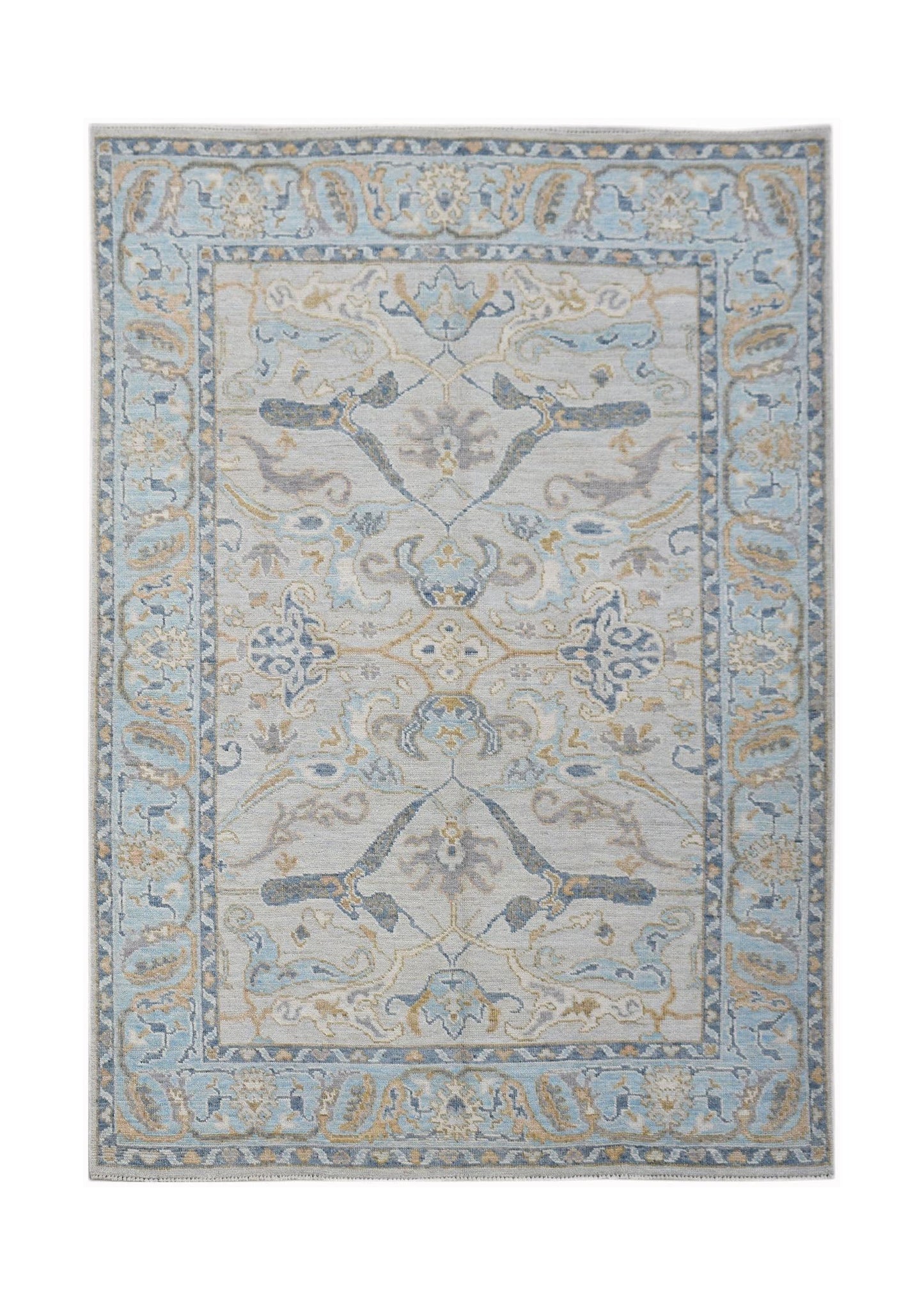 A handwoven transitional Oushak rug featuring a light blue and beige floral pattern.