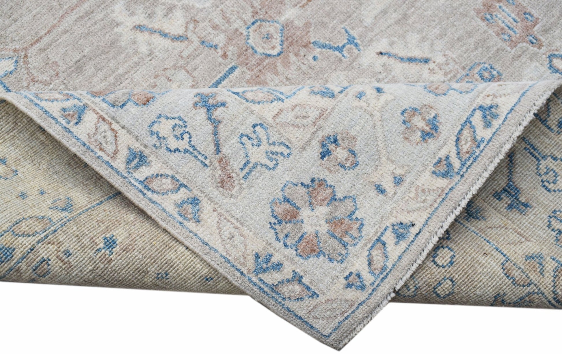 A handwoven transitional Oushak rug featuring a floral pattern in blue and beige tones.