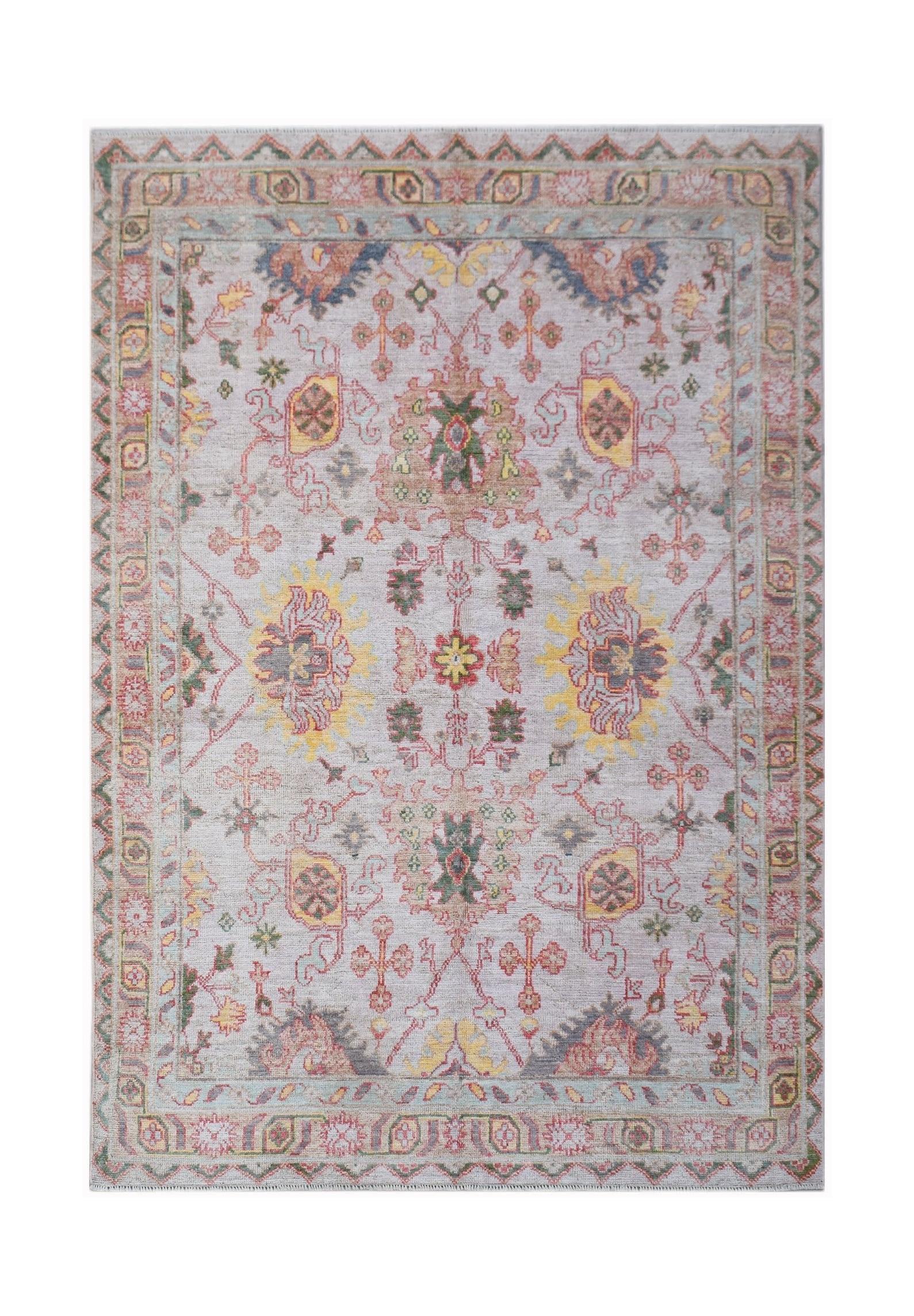 A handwoven transitional Oushak rug featuring a floral pattern in soft, contemporary colors.