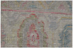 A handmade Afghan Oushak rug featuring a traditional pattern in soft, multicolored wool tones.