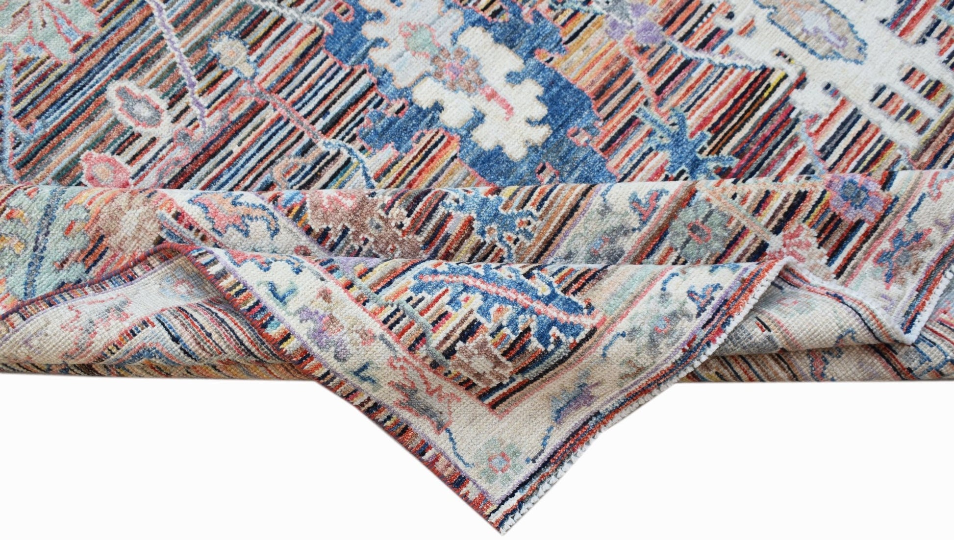 A handwoven transitional Oushak rug featuring a floral pattern in blue, red, and neutral tones.
