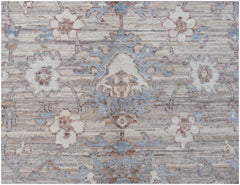 A transitional Oushak rug featuring a floral pattern in soft blue, beige, and brown tones.