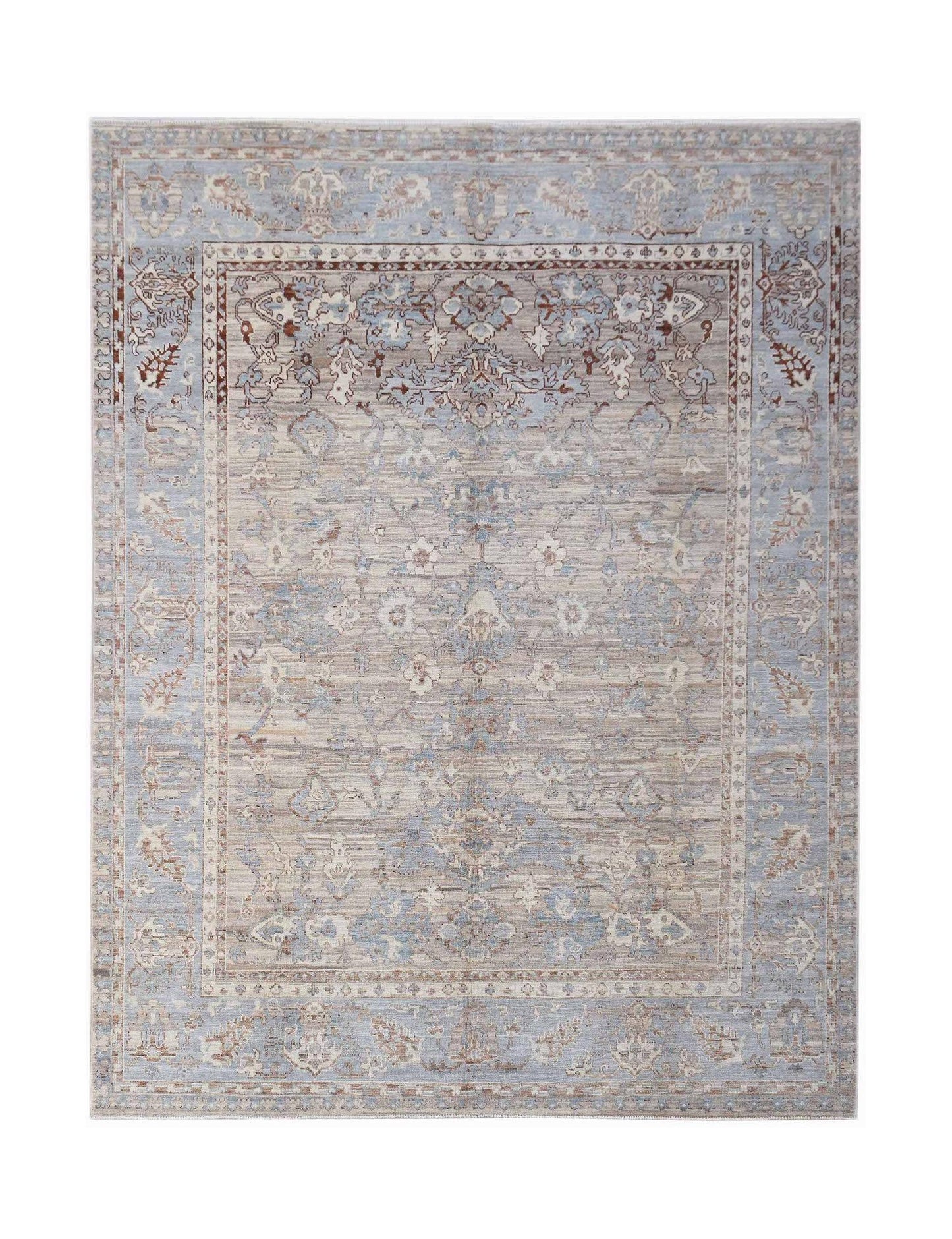 A handmade transitional Oushak rug featuring a light blue and beige floral pattern.