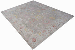 A rectangular transitional Oushak rug featuring a grey field with colorful floral motifs.