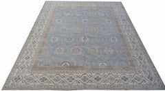 A handwoven transitional Oushak rug featuring a light blue field with a geometric floral pattern.