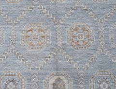 A handwoven transitional Oushak rug featuring a light blue field with geometric floral motifs.