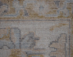 A close-up view of a handwoven transitional Oushak rug featuring a textured wool pile.