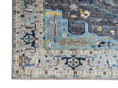 A handwoven transitional Oushak rug featuring a floral pattern in blue, grey, and multi-color tones.