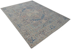 A handwoven transitional Oushak rug featuring a floral pattern in muted blue and grey tones.