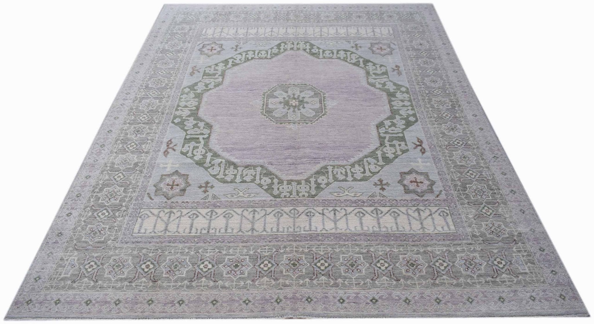 A handwoven transitional Oushak rug featuring a central medallion in soft lavender and sage green.