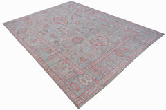A handwoven transitional Oushak rug featuring a floral pattern in soft blue and pink tones.
